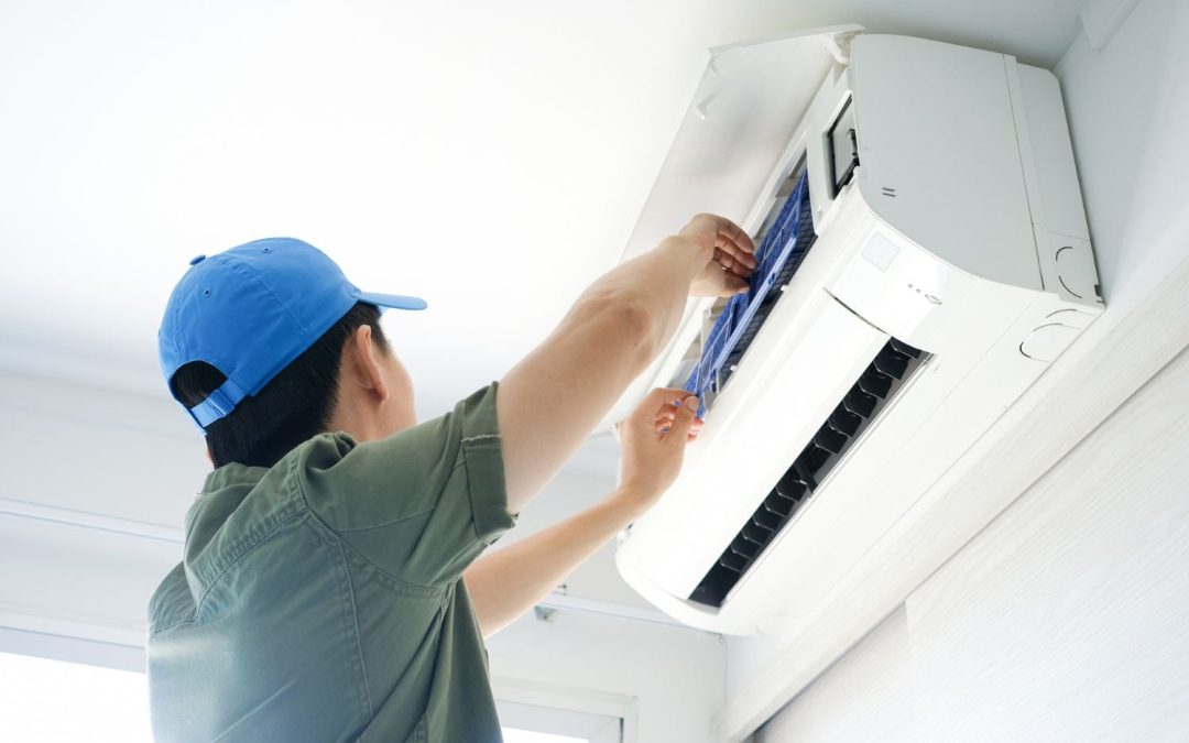 Air conditioning technician maintaining an indoor mini split system in Glendale, AZ