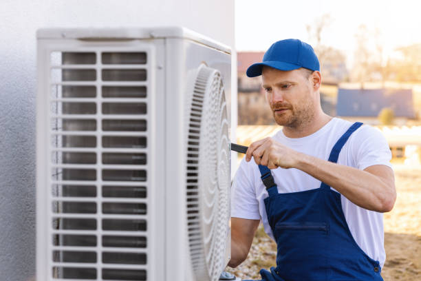 HVAC technician servicing an outdoor air conditioning unit in Glendale